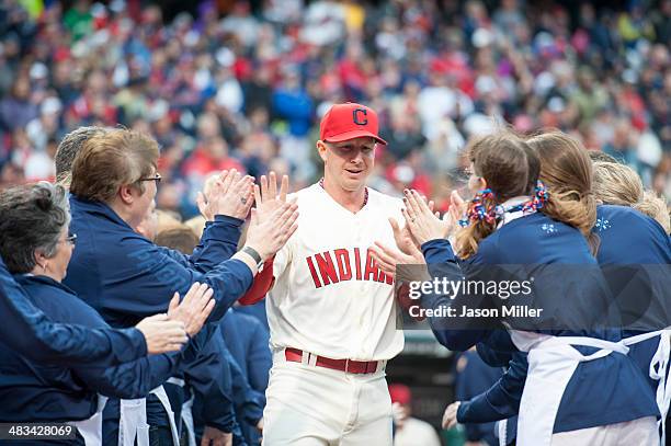 Infielder Elliot Johnson of the Cleveland Indians greets the crowd during player introductions prior to the home opener between the Cleveland Indians...