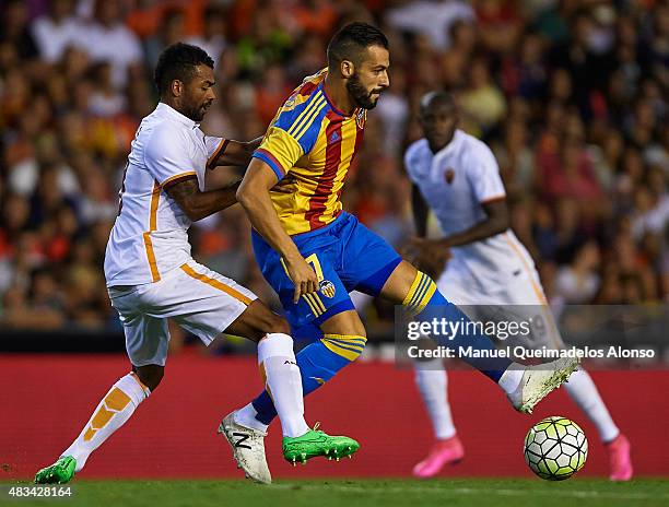 Alvaro Negredo of Valencia is tackled by Ashley Cole of Roma during the pre-season friendly match between Valencia CF and AS Roma at Estadio Mestalla...