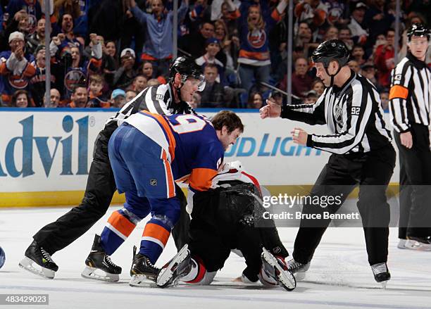 Matt Kassian of the Ottawa Senators falls to the ice while fighting with Brett Gallant of the New York Islanders in the first period at the Nassau...