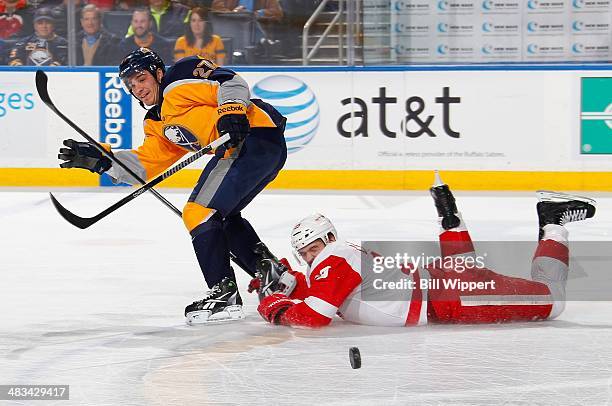 Brian Lashoff of the Detroit Red Wings dives to knock the puck away from Matt D'Agostini of the Buffalo Sabres on April 8, 2014 at the First Niagara...