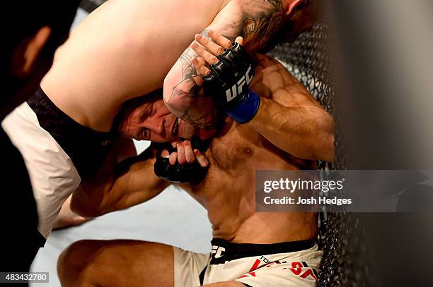 Chris Camozzi attempts a submission against Tom Watson of England in their middleweight bout during the UFC Fight Night event at Bridgestone Arena on...