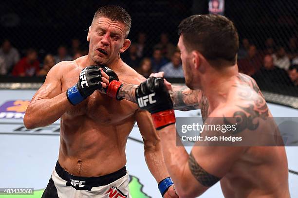 Chris Camozzi punches Tom Watson of England in their middleweight bout during the UFC Fight Night event at Bridgestone Arena on August 8, 2015 in...