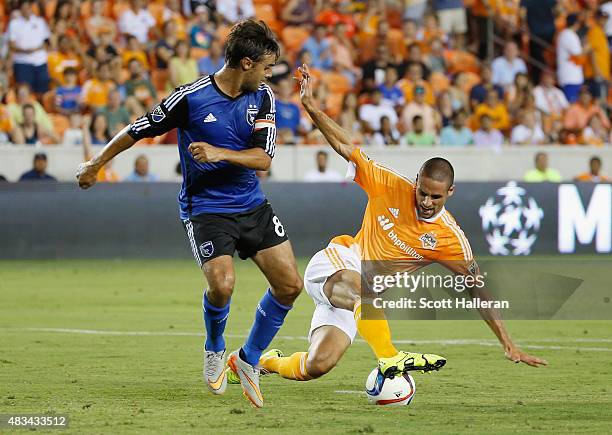 Chris Wondolowski of the San Jose Earthquakes battles for the ball with Raul Rodriguez of the Houston Dynamoduring their game at BBVA Compass Stadium...