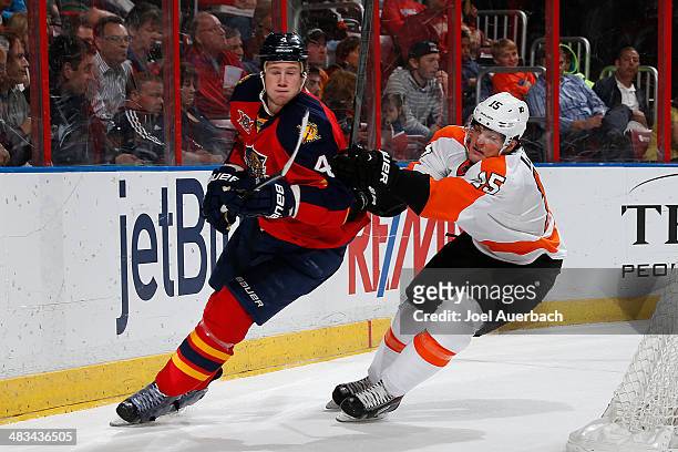 Dylan Olsen of the Florida Panthers and Tye McGinn of the Philadelphia Flyers circle the net during second period action at the BB&T Center on April...