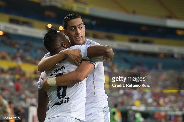 Rogelio Funes Mori of Monterrey celebrates with his teammates after scoring the first goal of his team during a 3rd round match between Atlas and...