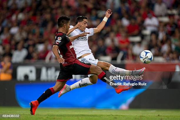 Juan Valenzuela of Atlas, fights for the ball with Rogelio Funes Mori of Monterrey during a 3rd round match between Atlas and Monterrey as part of...