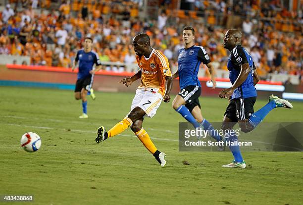 DaMarcus Beasley of Houston Dynamo scores a second half goal past two San Jose Earthquakes defenders during their game at BBVA Compass Stadium on...