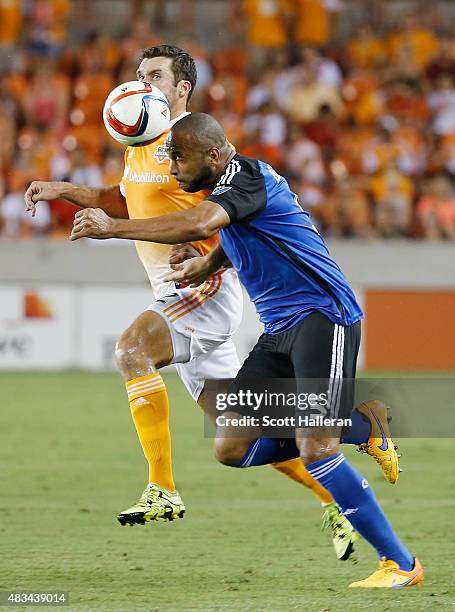 Victor Bernardez of the San Jose Earthquakes battles for the ball with Will Bruin of the Houston Dynamo during their game at BBVA Compass Stadium on...