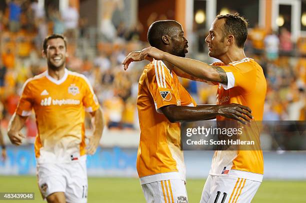 Brad Davis of Houston Dynamo hugs DaMarcus Beasley after Beasley scored a second half goal against the San Jose Earthquakes during their game at BBVA...