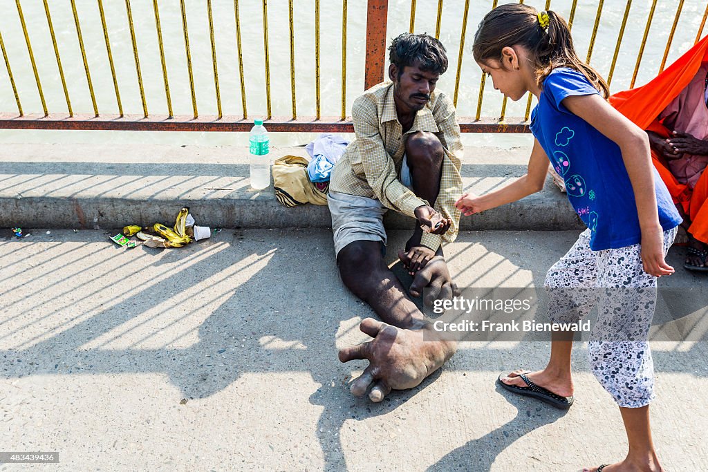 A beggar with Elephantiasis at his feet is receiving some...
