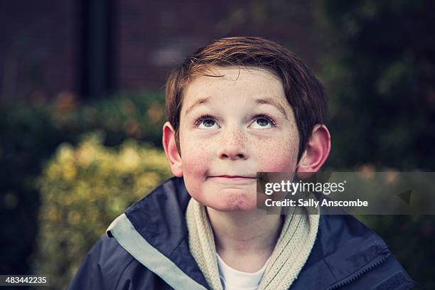 happy smiling little boy looking up - boy wondering stock pictures, royalty-free photos & images