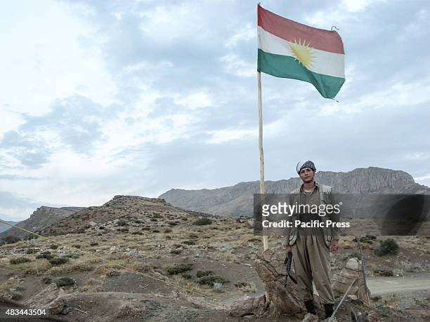 Man standing near a flag pole. The PDKI movement is in Iranian borders, one kilometer away from the Iranian troops and where the Peshmerga stays.