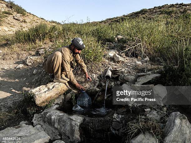 Man fetching water. The PDKI movement is in Iranian borders, one kilometer away from the Iranian troops and where the Peshmerga stays.