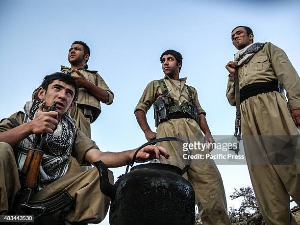 Early morning Peshmergas gather around a tea pot. The PDKI movement is in Iranian borders, one kilometer away from the Iranian troops and where the...
