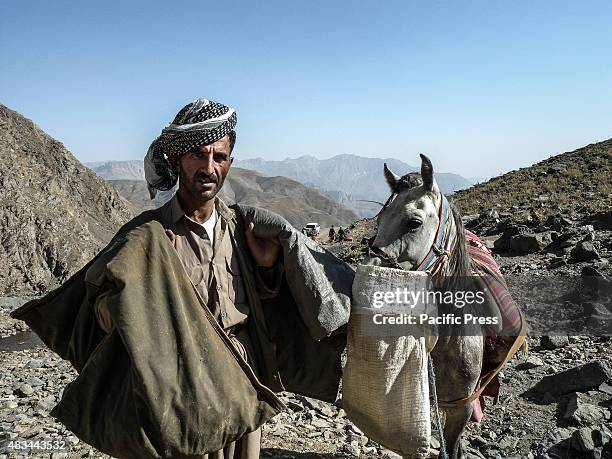 Smuggler with his horse. The PDKI movement is in Iranian borders, one kilometer away from the Iranian troops and where the Peshmerga stays.