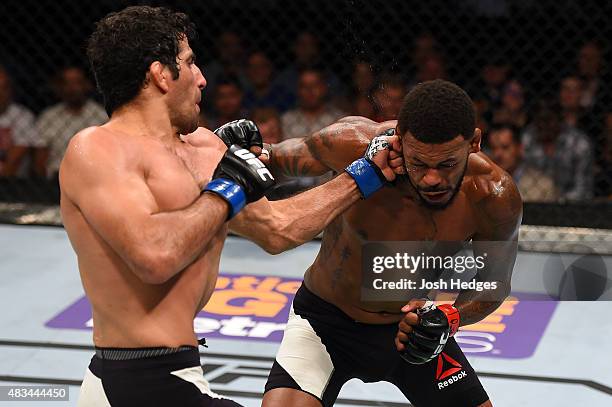 Beneil Dariush punches Michael Johnson in their lightweight bout during the UFC Fight Night event at Bridgestone Arena on August 8, 2015 in...