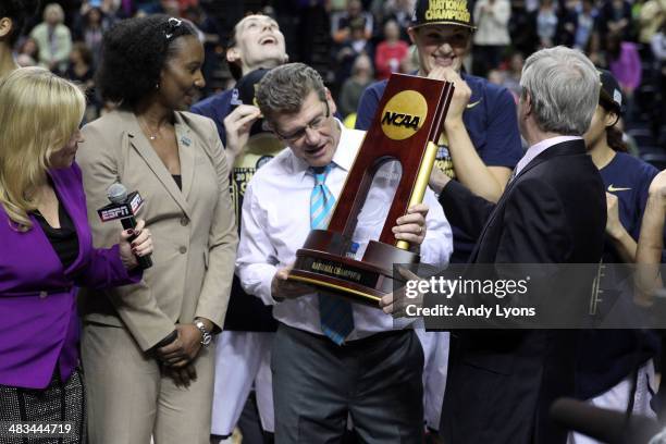 Head coach Geno Auriemma of the Connecticut Huskies holds the trophy after defeating the Notre Dame Fighting Irish 79 to 58 in the NCAA Women's Final...
