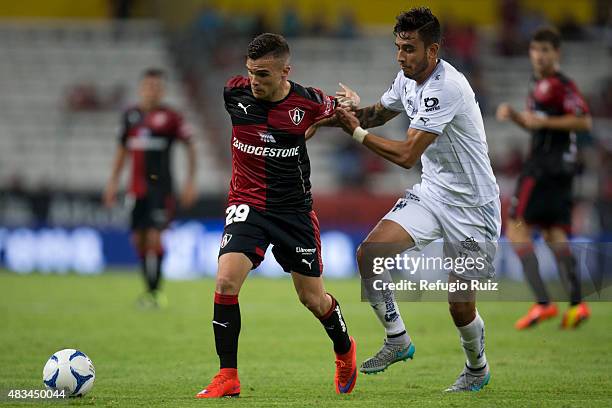 Christian Tabo of Atlas fights for the ball with Jesus Zavala of Monterrey during a 3rd round match between Atlas and Monterrey as part of the...