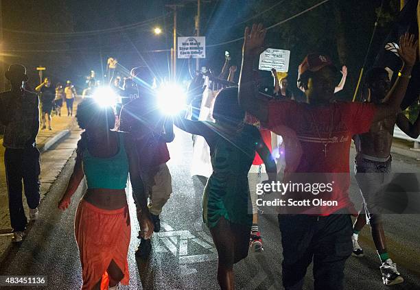 Demonstrators march to mark the first anniversary of the death of Michael Brown on August 8, 2015 in Ferguson, Missouri. Brown, an unarmed black...