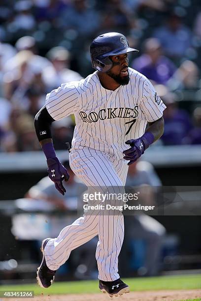 Jose Reyes of the Colorado Rockies takes an at bat and sprints for first against the Seattle Mariners during interleague play at Coors Field on...