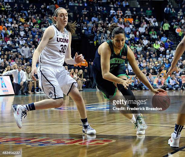 Taya Reimer of the Notre Dame Fighting Irish dribbles against Breanna Stewart of the Connecticut Huskies during the NCAA Women's Basketball...
