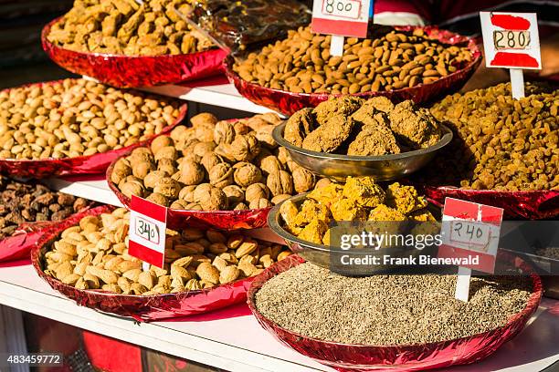 Nuts, dates, almonds, raisins and caraway seeds are displayed in bowls in the Old Delhi spice market.