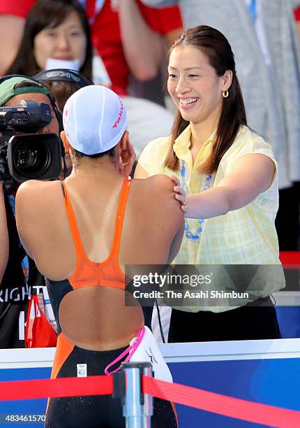 Kanako Watanabe of Japan is congratulated by former swinner Aa terakawa after winning the gold medal in the Women's 200m Breaststroke on day fourteen...
