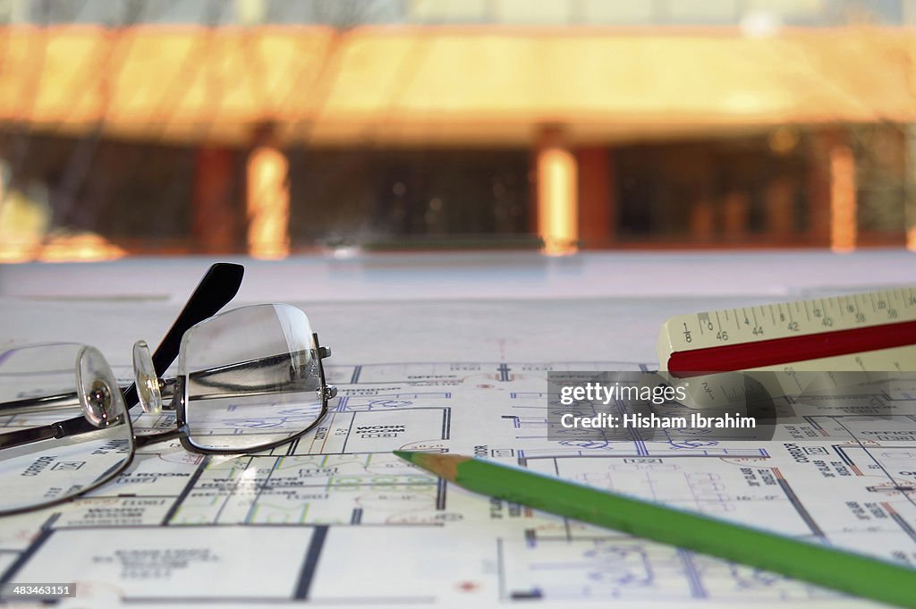 Architect's plans, scale, pencil and glasses