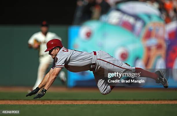 Tony Campana of the Arizona Diamondbacks slides safely into third base against the San Francisco Giants during the game at AT&T Park on Tuesday,...