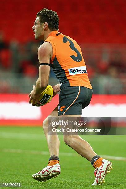 Stephen Coniglio of the Giants looks to kick during the round 19 AFL match between the Greater Western Sydney Giants and the Essendon Bombers at...