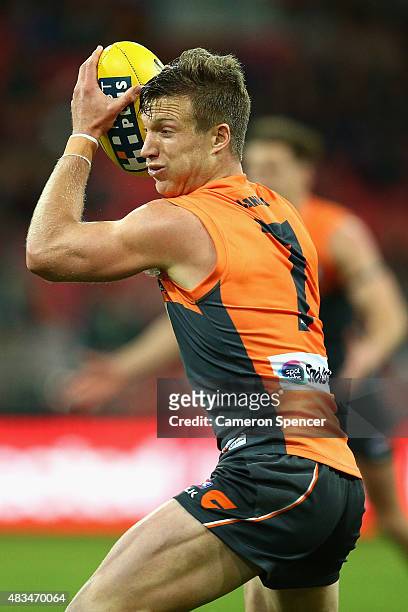 Rhys Palmer of the Giants catches the ball during the round 19 AFL match between the Greater Western Sydney Giants and the Essendon Bombers at...