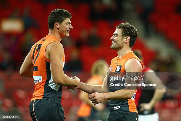 Stephen Coniglio of the Giants celebrates kicking a goal with team mate Jonathon Patton during the round 19 AFL match between the Greater Western...