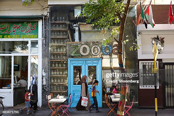 Pedestrians walk past a Zooba restaurant on a street in Cairo, Egypt, on Friday, Aug. 7, 2015. The Suez canal extension and other construction...