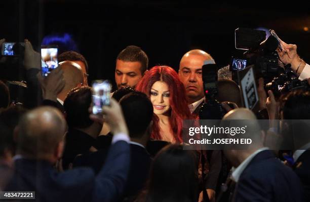 Lebanese pop star Haifa Wehbe smiles as she arrives for the Premiere of he movie 'Halawet Rooh' at a movie theatre in the town of Dbayeh, North of...