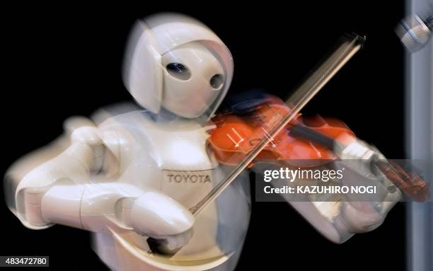 Violin playing robot, a series of humanoid robots from Toyota Partner Robot, is displayed at a robot event for children in Tokyo on August 9, 2015....
