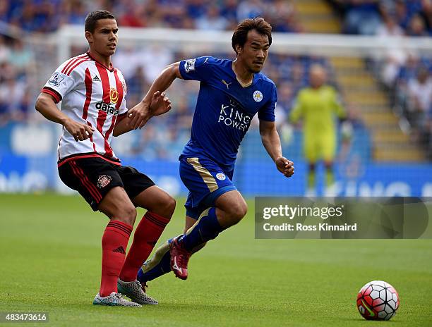Shinji Okazaki of Leicester City is challenged by Jack Rodwell of Sunderland during the Barclays Premier League match between Leicester City and...