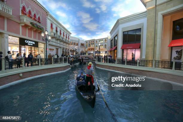 People enjoy a ride on a gondola on April 3, 2014 in Las Vegas, United States. With the replica of the Effiel Tower located outside the Paris Las...