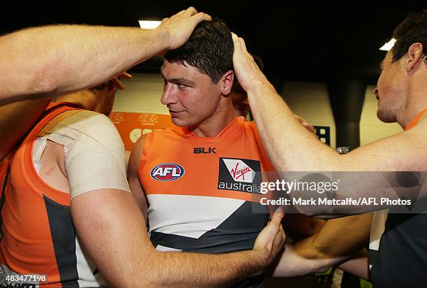 Jonathon Patton of the Giants is congratulated by team mates after victory in the round 19 AFL match between the Greater Western Sydney Giants and...