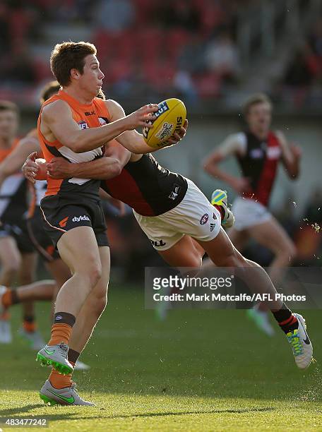 Toby Greene of the Giants is tackled by Mark Baguley of the Bombers during the round 19 AFL match between the Greater Western Sydney Giants and the...