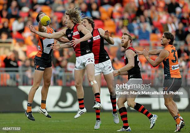 Dyson Heppell of the Bombers and Lachie Whitfield of the Giants compete for the ball during the round 19 AFL match between the Greater Western Sydney...