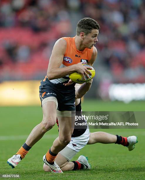 Josh Kelly of the Giants is tackled by Nick O'Brien of the Bombers during the round 19 AFL match between the Greater Western Sydney Giants and the...
