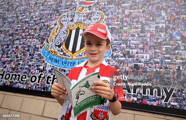 Southampton fan reads the match day programme prior to the Barclays Premier League match between Newcastle United and Southampton at St James' Park...