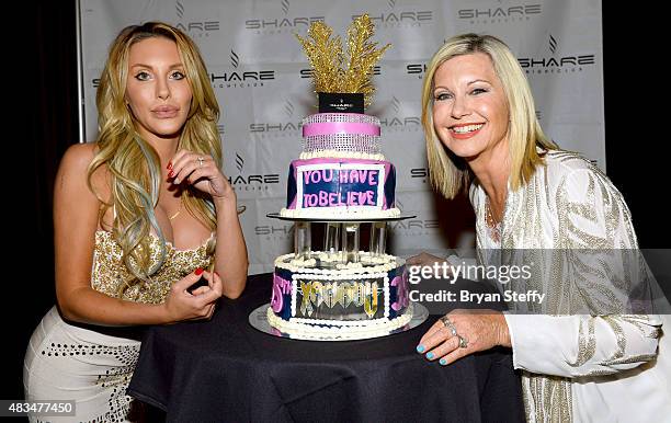 Singer Chloe Lattanzi and her mother, singer/actress Olivia Newton-John, pose with a celebratory cake as they celebrate the 35th anniversary of...