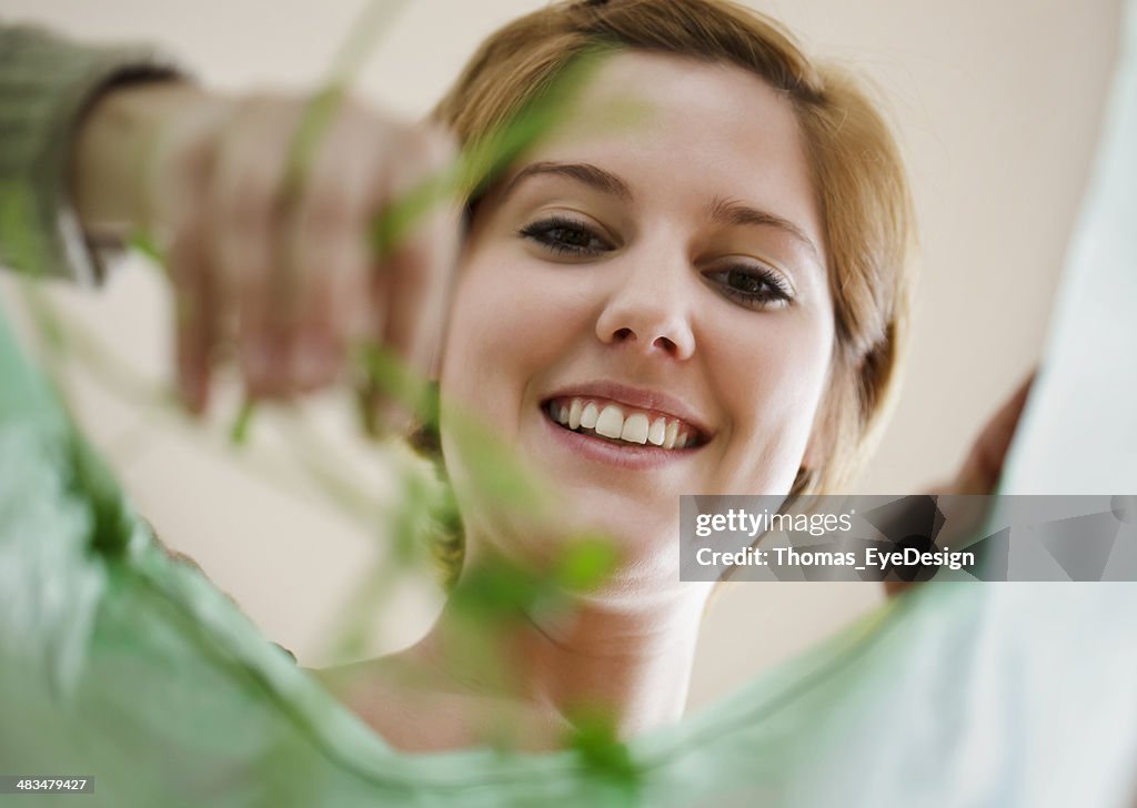 Woman Placing Organic Garbage in Recycling Bag