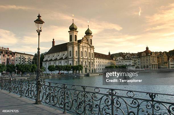 baroque cathedral on luzern waterfront - luzern stock pictures, royalty-free photos & images