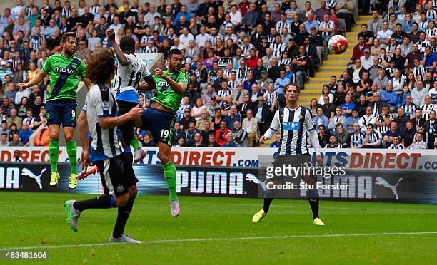 Graziano Pelle of Southampton outjumps Chancel Mbemba of Newcastle United to score their first goal during the Barclays Premier League match between...
