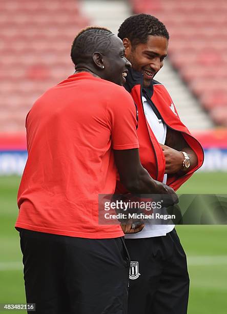 Mamadou Sakho of Liverpool dresses ex-Liverpool player Glen Johnson of Stoke City in a Liverpool tracksuit top prior to the Barclays Premier League...