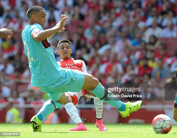 Alexis Sanchez of Arsenal under pressure from Winston Reid of West Ham during the Barclays Premier League match between Arsenal and West Ham United at