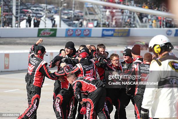 The pit crew for the Haas Automation Chevy SS driven by Kurt Busch celebrate on pit road after winning the STP Gas Booster 500 at the Martinsville...