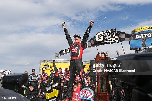 Kurt Busch, driver of the Haas Automation Chevy SS, celebrates in victory lane after winning the STP Gas Booster 500 at the Martinsville Speedway in...
